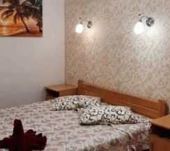 Стандартный однокомнатный номер на двоих, площадью 12м², оформленный в современном стиле, с одной двуспальной деревянной кроватью, вместительным шкафом, телевизором, холодильником. Душ и туалет в номере. Источник: https://zolotoy-pesok.ru/standart-2 в Золотой песок