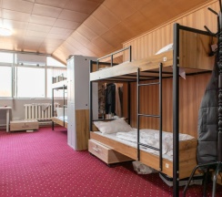 Кровать в общем номере с красивым видом из окна в Almaty BackPackers