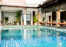 Кровать в общем номере в Baan Chankaew Hotel